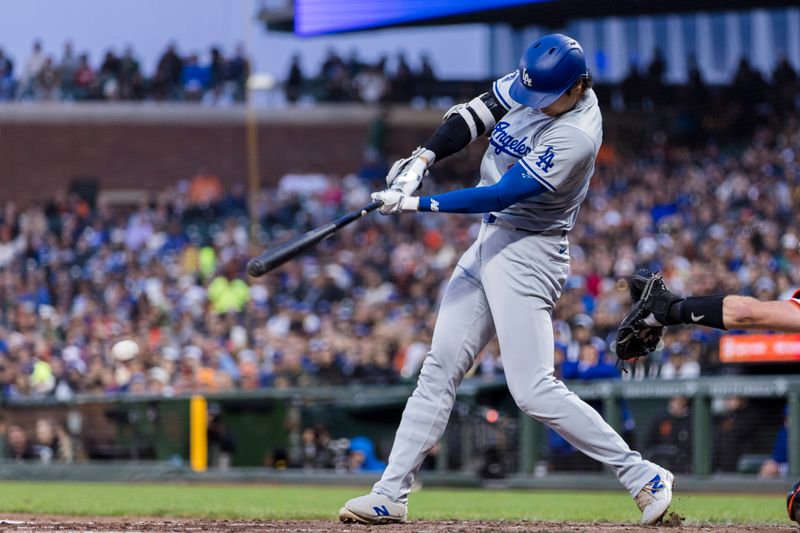 May 15, 2024; San Francisco, California, USA; Los Angeles Dodgers designated hitter Shohei Ohtani (17) hits a single against the San Francisco Giants during the fifth inning at Oracle Park. Mandatory Credit: John Hefti-USA TODAY Sports