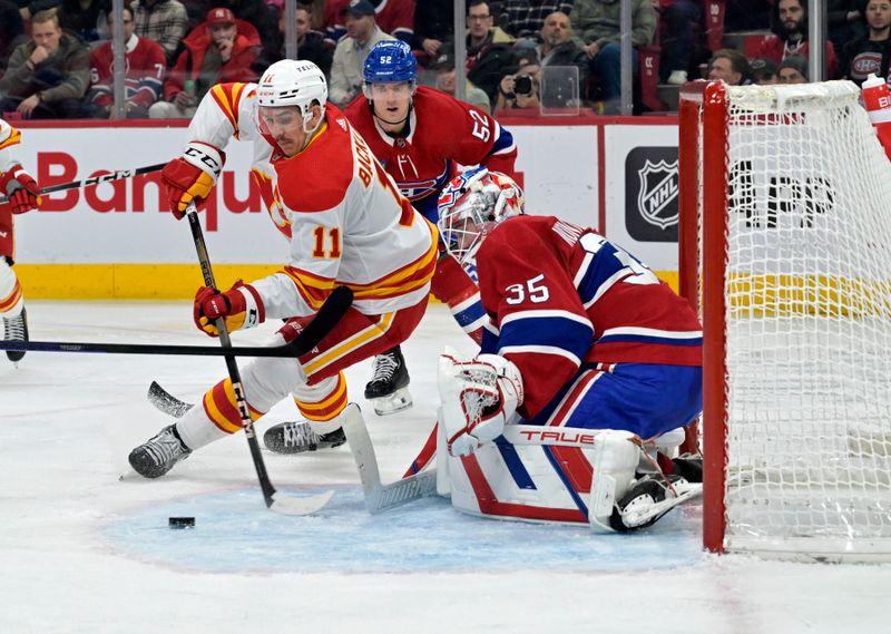 Nov 14, 2023; Montreal, Quebec, CAN; Montreal Canadiens goalie Sam Montembeault (35) stops Calgary Flames forward Mikael Backlund (11) during the second period at the Bell Centre. Mandatory Credit: Eric Bolte-USA TODAY Sports