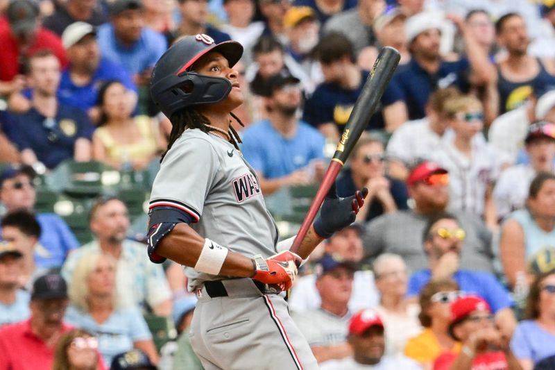 Jul 13, 2024; Milwaukee, Wisconsin, USA; Washington Nationals shortstop C.J. Abrams (5) hits a 2-run home run against the Milwaukee Brewers in the ninth inning at American Family Field. Mandatory Credit: Benny Sieu-USA TODAY Sports