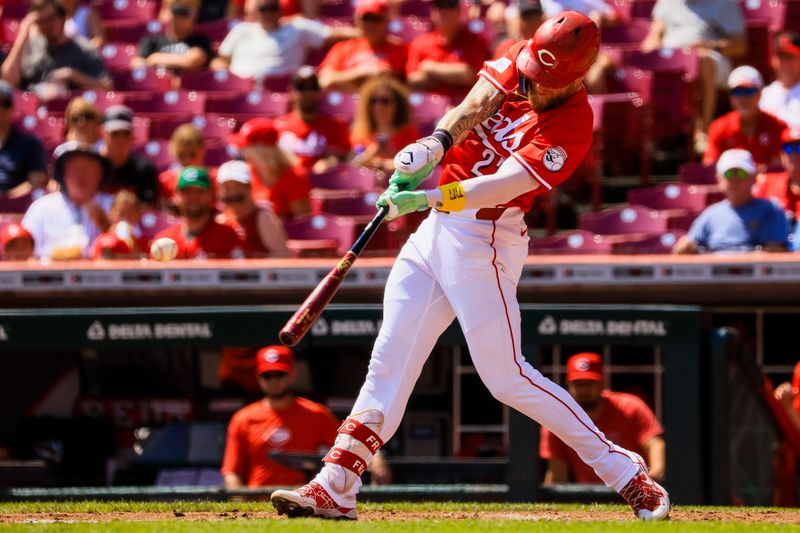 Sep 5, 2024; Cincinnati, Ohio, USA; Cincinnati Reds outfielder Jake Fraley (27) hits a single against the Houston Astros in the second inning at Great American Ball Park. Mandatory Credit: Katie Stratman-Imagn Images