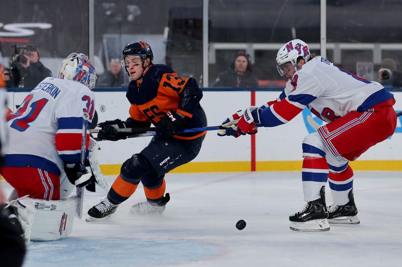 Feb 18, 2024; East Rutherford, New Jersey, USA; New York Rangers goaltender Igor Shesterkin (31) makes a save against New York Islanders center Mathew Barzal (13) in front of Rangers defenseman Jacob Trouba (8) during the second period of a Stadium Series ice hockey game at MetLife Stadium. Mandatory Credit: Brad Penner-USA TODAY Sports