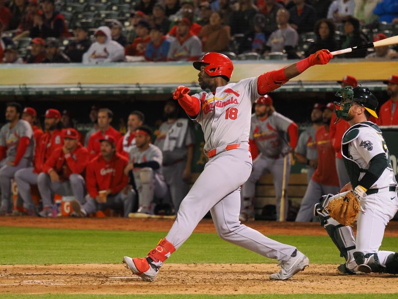 Apr 16, 2024; Oakland, California, USA; St. Louis Cardinals right fielder Jordan Walker (18) hits a sacrifice fly to score a run against the Oakland Athletics during the sixth inning at Oakland-Alameda County Coliseum. Mandatory Credit: Kelley L Cox-USA TODAY Sports