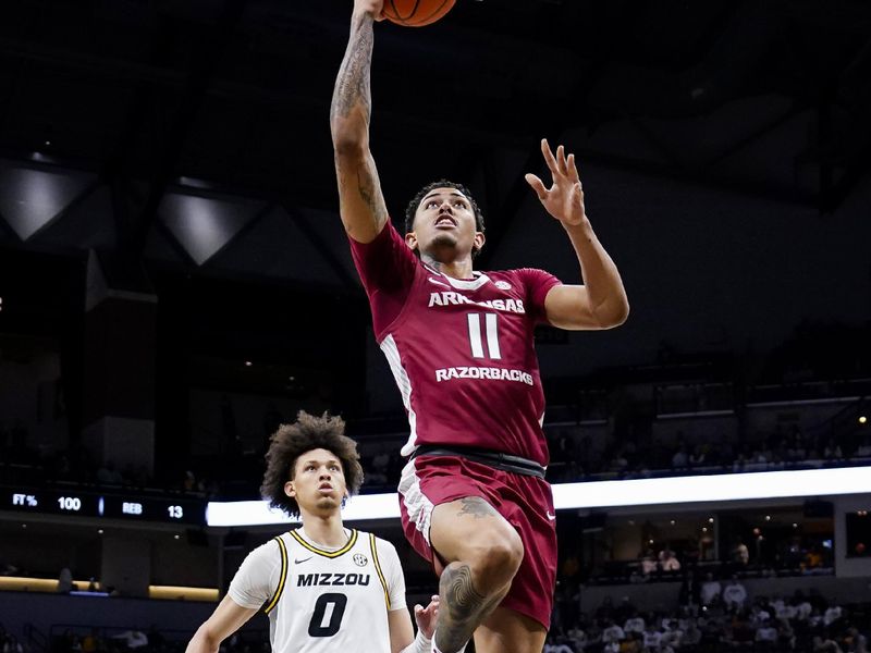 Jan 31, 2024; Columbia, Missouri, USA; Arkansas Razorbacks forward Jalen Graham (11) shoots a layup against Missouri Tigers forward Jordan Butler (0) during the second half at Mizzou Arena. Mandatory Credit: Jay Biggerstaff-USA TODAY Sports