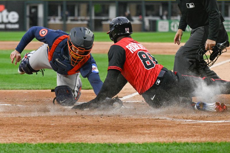 May 2, 2025; Chicago, Illinois, USA;  Chicago White Sox outfielder Luis Robert Jr. (88) is tagged out by Houston Astros catcher Yainer Diaz (21) during the first inning at Rate Field. Mandatory Credit: Matt Marton-Imagn Images