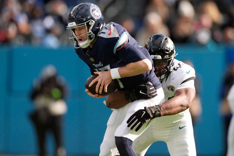 Tennessee Titans quarterback Ryan Tannehill (17) is sacked by Jacksonville Jaguars linebacker Travon Walker (44) during the first half of an NFL football game Sunday, Jan. 7, 2024, in Nashville, Tenn. (AP Photo/George Walker IV)