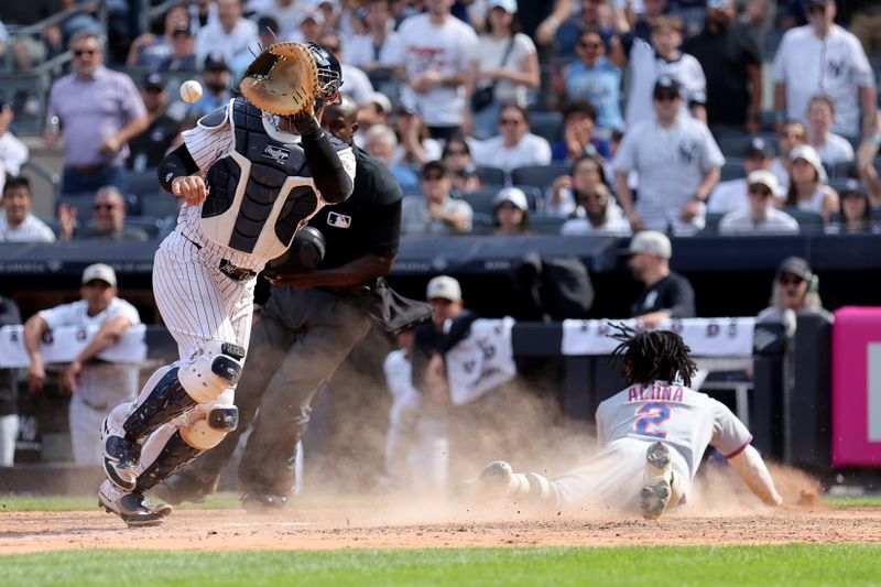 May 17, 2025; Bronx, New York, USA; New York Mets pinch runner Luisangel Acuna (2) scores the go ahead run before New York Yankees catcher J.C. Escarra (25) receives the throw on a sacrifice fly by Mets shortstop Francisco Lindor (not pictured) during the ninth inning at Yankee Stadium. Mandatory Credit: Brad Penner-Imagn Images