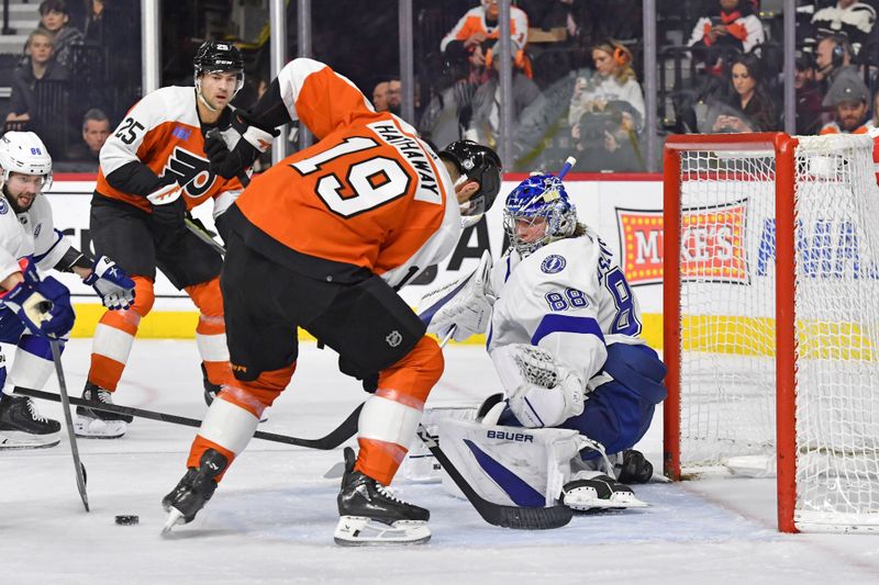 Feb 27, 2024; Philadelphia, Pennsylvania, USA; Philadelphia Flyers right wing Garnet Hathaway (19) and Tampa Bay Lightning goaltender Andrei Vasilevskiy (88) battle for the puck during the first period at Wells Fargo Center. Mandatory Credit: Eric Hartline-USA TODAY Sports