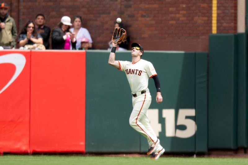 Jun 8, 2025; San Francisco, California, USA; San Francisco Giants right fielder Mike Yastrzemski (5) makes the catch of a fly ball by Atlanta Braves catcher Sean Murphy during the fourth inning at Oracle Park. Mandatory Credit: D. Ross Cameron-Imagn Images