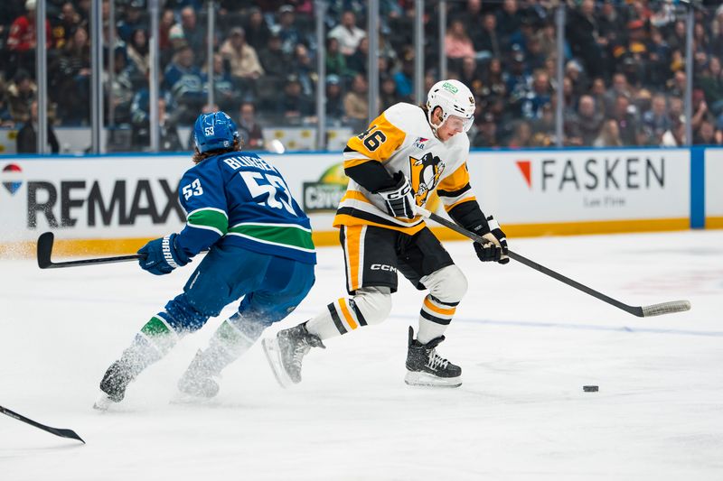 Jan 25, 2026; Vancouver, British Columbia, CAN; Vancouver Canucks forward Teddy Blueger (53) defends against Pittsburgh Penguins forward Blake Lizotte (46) in the first period at Rogers Arena. Mandatory Credit: Bob Frid-Imagn Images