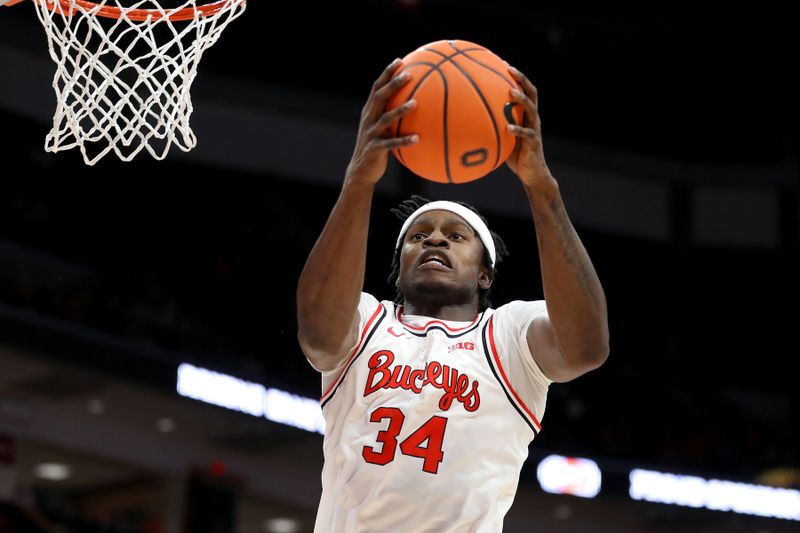 Dec 3, 2023; Columbus, Ohio, USA;  Ohio State Buckeyes center Felix Okpara (34) grabs the rebound during the first half against the Minnesota Golden Gophers at Value City Arena. Mandatory Credit: Joseph Maiorana-USA TODAY Sports