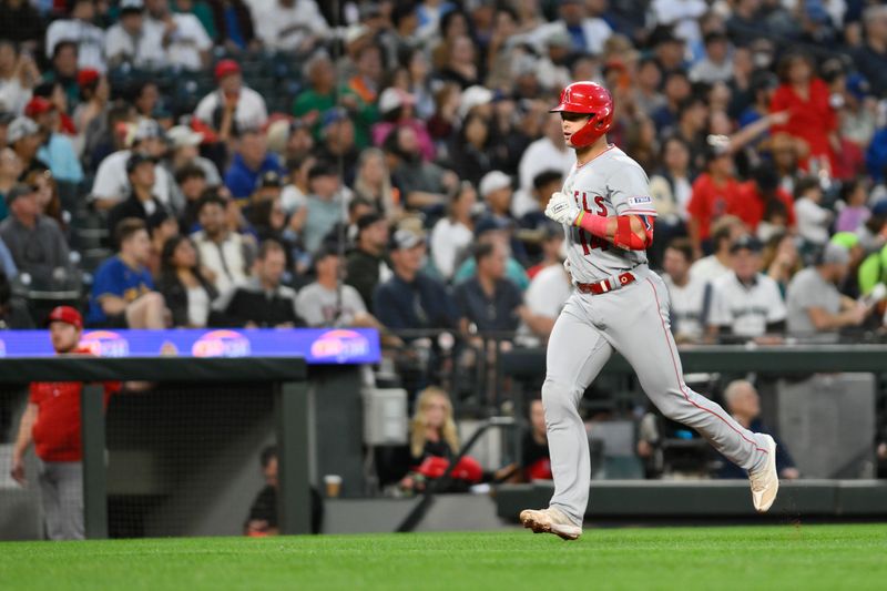 Sep 11, 2023; Seattle, Washington, USA; Los Angeles Angels catcher Logan O'Hoppe (14) jogs towards home plate after hitting a home run against the Seattle Mariners during the fourth inning at T-Mobile Park. Mandatory Credit: Steven Bisig-USA TODAY Sports