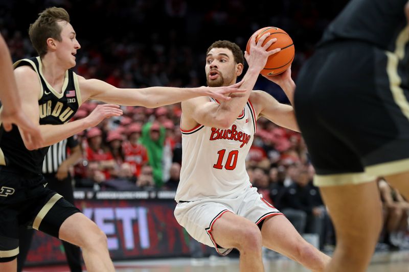 Feb 18, 2024; Columbus, Ohio, USA;  Ohio State Buckeyes forward Jamison Battle (10) controls the ball as Purdue Boilermakers guard Fletcher Loyer (2) defends during the second half at Value City Arena. Mandatory Credit: Joseph Maiorana-USA TODAY Sports