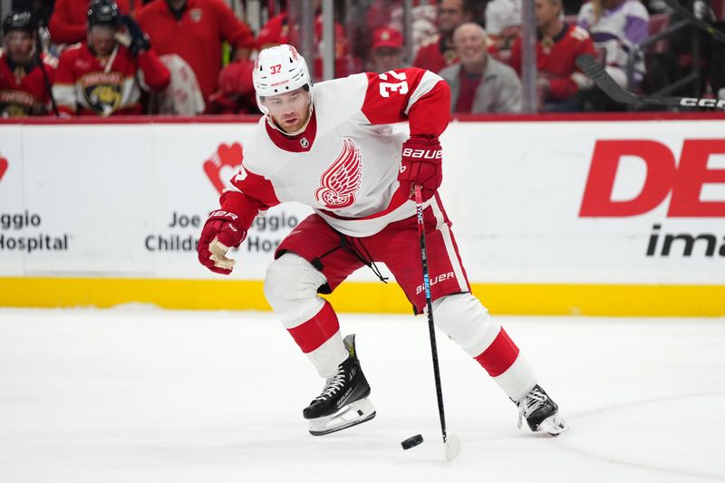 Jan 17, 2024; Sunrise, Florida, USA; Detroit Red Wings left wing J.T. Compher (37) plays the puck against the Florida Panthers during the second period at Amerant Bank Arena. Mandatory Credit: Jasen Vinlove-USA TODAY Sports