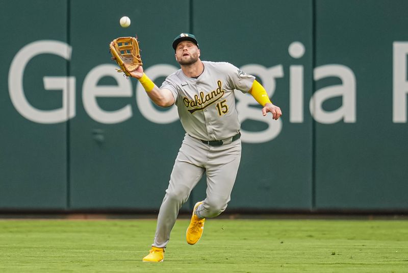 May 31, 2024; Cumberland, Georgia, USA; Oakland Athletics right fielder Seth Brown (15) catches a fly ball hit by Atlanta Braves first baseman Matt Olson (28) (not shown) during the first inning at Truist Park. Mandatory Credit: Dale Zanine-USA TODAY Sports