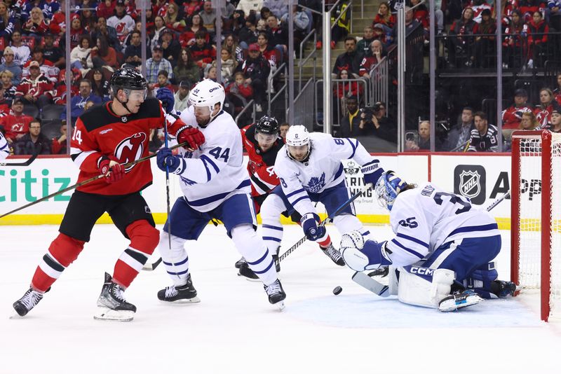 Oct 10, 2024; Newark, New Jersey, USA; Toronto Maple Leafs goaltender Dennis Hildeby (35) makes a save against the New Jersey Devils during the second period at Prudential Center. Mandatory Credit: Ed Mulholland-Imagn Images