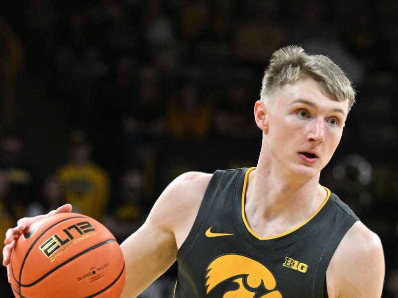 Feb 2, 2024; Iowa City, Iowa, USA; Iowa Hawkeyes guard Josh Dix (4) controls the ball against the Ohio State Buckeyes during the second half at Carver-Hawkeye Arena. Mandatory Credit: Jeffrey Becker-USA TODAY Sports