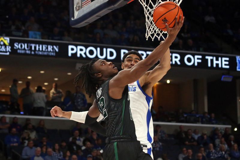 Feb 11, 2024; Memphis, Tennessee, USA; Tulane Green Wave guard Kolby King (12) shoots as Memphis Tigers forward Nicholas Jourdain (2) defends during the second half at FedExForum. Mandatory Credit: Petre Thomas-USA TODAY Sports