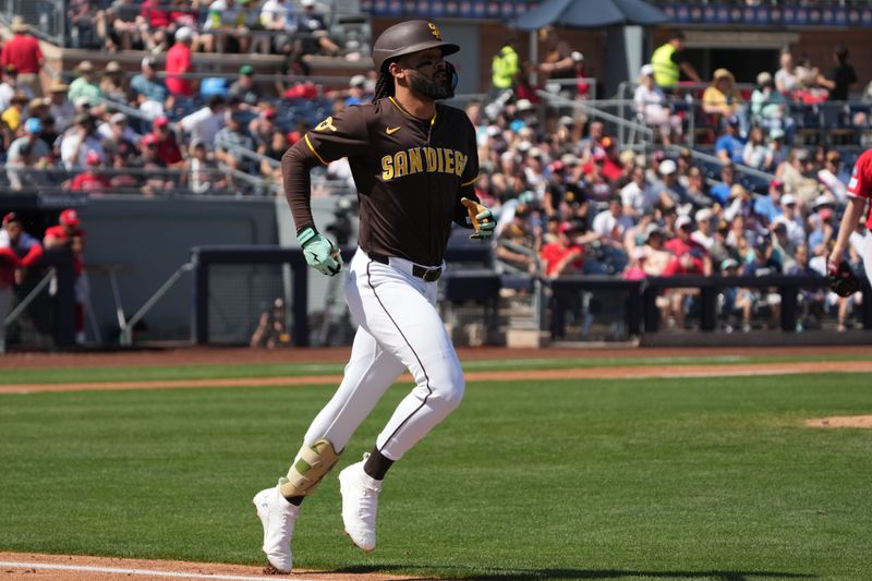 Mar 22, 2025; Peoria, Arizona, USA; San Diego Padres outfielder Fernando Tatis Jr. (23) runs to first-base against the Cincinnati Reds  in the third inning at Peoria Sports Complex. Mandatory Credit: Rick Scuteri-Imagn Images