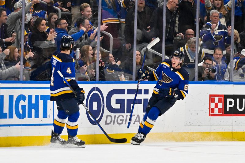 Dec 6, 2023; St. Louis, Missouri, USA;  St. Louis Blues left wing Jake Neighbours (63) celebrates with defenseman Nick Leddy (4) after scoring against the Vegas Golden Knights during the first period at Enterprise Center. Mandatory Credit: Jeff Curry-USA TODAY Sports