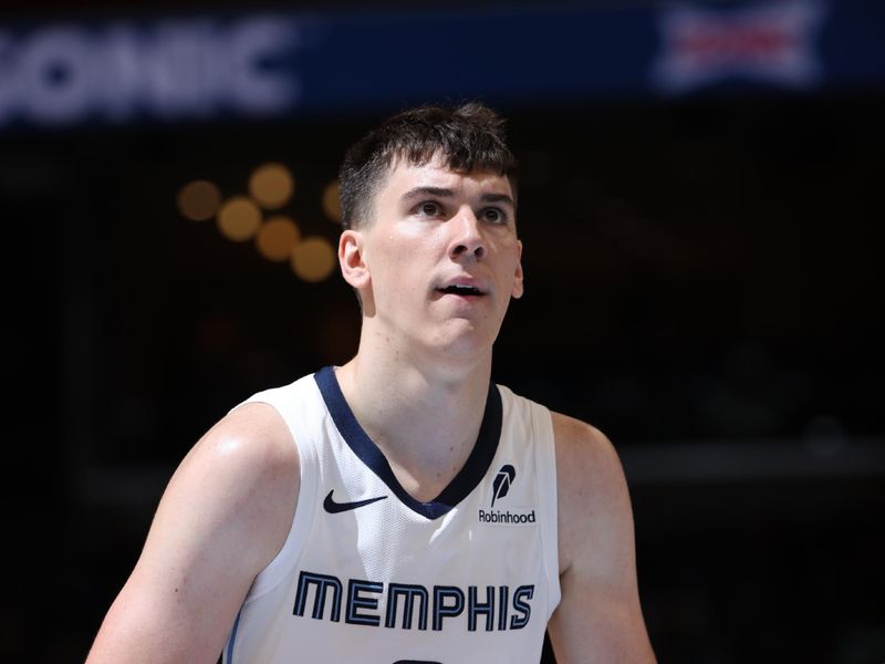 MEMPHIS, TN - OCTOBER 10: Jake LaRavia #3 of the Memphis Grizzlies shoots a free throw during the game against the Charlotte Hornets during a NBA Preseason game on October 10, 2024 at FedExForum in Memphis, Tennessee. NOTE TO USER: User expressly acknowledges and agrees that, by downloading and or using this photograph, User is consenting to the terms and conditions of the Getty Images License Agreement. Mandatory Copyright Notice: Copyright 2024 NBAE (Photo by Joe Murphy/NBAE via Getty Images)