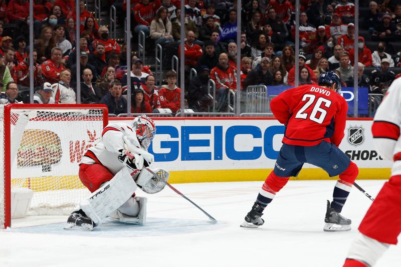 Jan 5, 2024; Washington, District of Columbia, USA; Washington Capitals right wing Nic Dowd (26) scores a goal on Carolina Hurricanes goaltender Pyotr Kochetkov (52) in the first period at Capital One Arena. Mandatory Credit: Geoff Burke-USA TODAY Sports