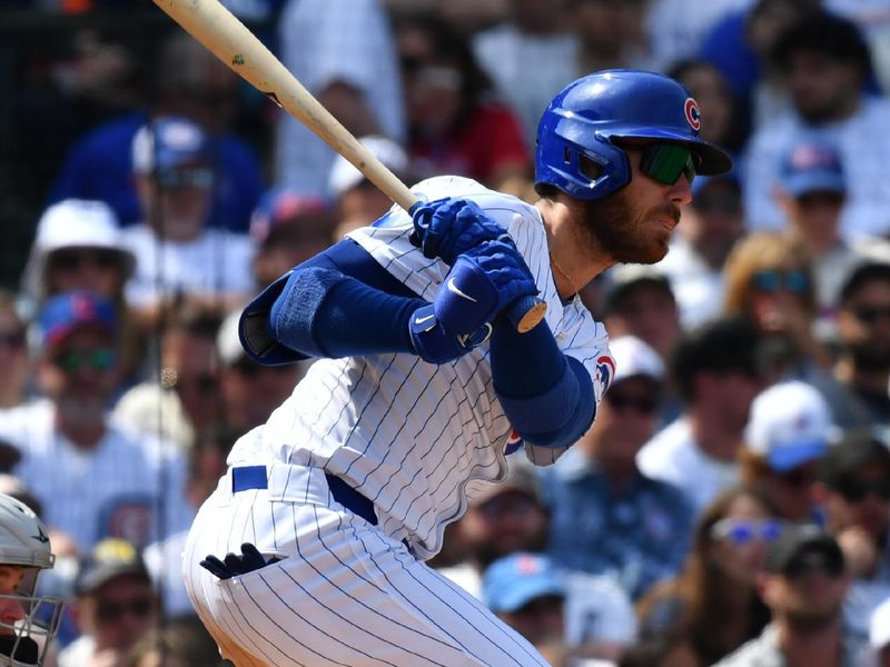 Aug 22, 2024; Chicago, Illinois, USA;  Chicago Cubs right fielder Cody Bellinger (24) hits an RBI single during the fourth inning against the Detroit Tigers at Wrigley Field. Mandatory Credit: Patrick Gorski-USA TODAY Sports
