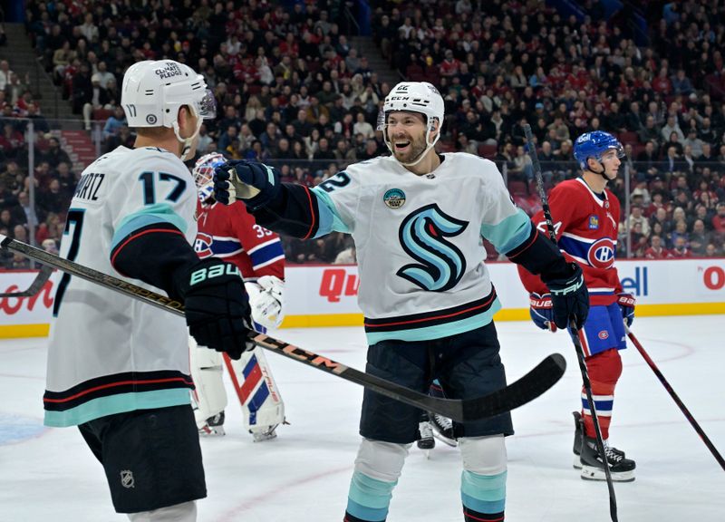 Oct 29, 2024; Montreal, Quebec, CAN; Seattle Kraken forward Oliver Bkorkstrand (22) celebrates with forward Jaden Schwartz (17) after scoring a goal against Montreal Canadiens goalie Sam Montembeault (35) during the first period at the Bell Centre. Mandatory Credit: Eric Bolte-Imagn Images