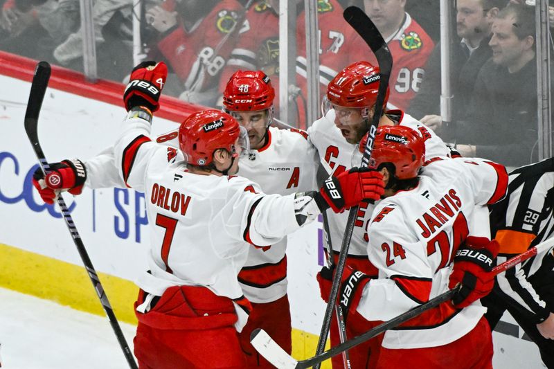 Jan 20, 2025; Chicago, Illinois, USA;  Carolina Hurricanes center Jordan Staal (11), second from right, celebrates with teammates  after scoring a goal against the Chicago Blackhawks during the third period at the United Center. Mandatory Credit: Matt Marton-Imagn Images