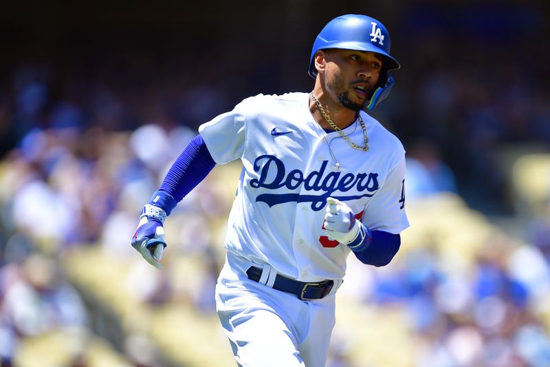 Jul 26, 2023; Los Angeles, California, USA; Los Angeles Dodgers right fielder Mookie Betts (50) runs after hitting a single against the Toronto Blue Jays during the first inning at Dodger Stadium. Mandatory Credit: Gary A. Vasquez-USA TODAY Sports