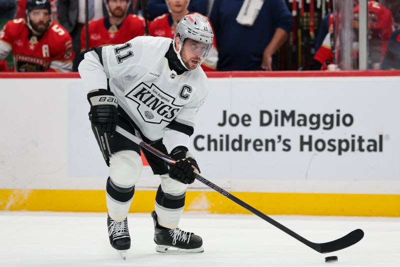 Dec 17, 2025; Sunrise, Florida, USA; Los Angeles Kings center Anze Kopitar (11) moves the puck against the Florida Panthers during the first period at Amerant Bank Arena. Mandatory Credit: Sam Navarro-Imagn Images
