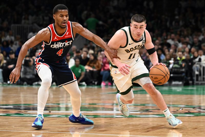 BOSTON, MASSACHUSETTS - APRIL 14: Payton Pritchard #11 of the Boston Celtics drives to the basket against Jared Butler #4 of the Washington Wizards during the fourth quarter at the TD Garden on April 14, 2024 in Boston, Massachusetts. NOTE TO USER: User expressly acknowledges and agrees that, by downloading and or using this photograph, User is consenting to the terms and conditions of the Getty Images License Agreement. (Photo by Brian Fluharty/Getty Images)