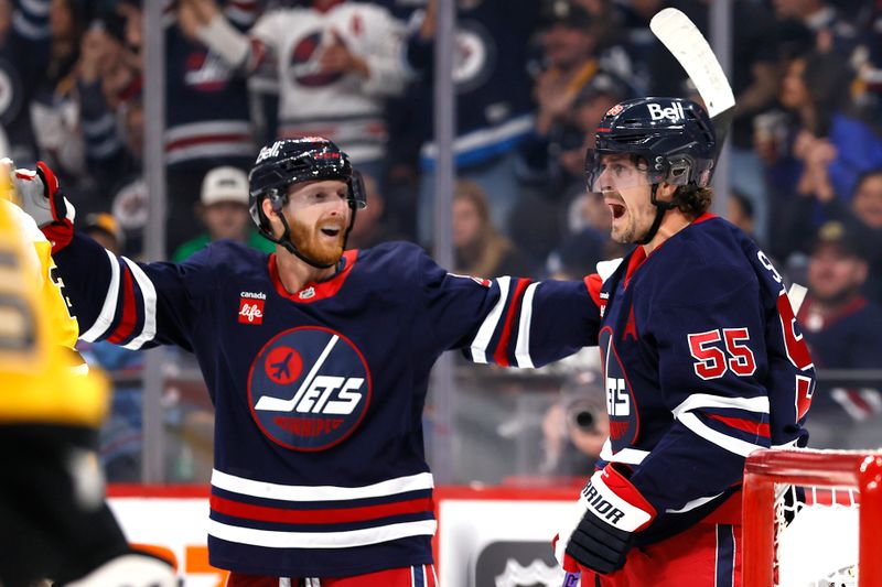 Oct 20, 2024; Winnipeg, Manitoba, CAN; Winnipeg Jets center Mark Scheifele (55) celebrates his second period goal with Winnipeg Jets left wing Kyle Connor (81) against the Pittsburgh Penguins at Canada Life Centre. Mandatory Credit: James Carey Lauder-Imagn Images