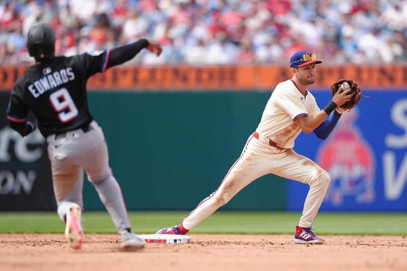 Apr 19, 2025; Philadelphia, Pennsylvania, USA; Philadelphia Phillies infielder Trea Turner (7) turns a double play against the Miami Marlins in the fifth inning at Citizens Bank Park. Mandatory Credit: Kyle Ross-Imagn Images