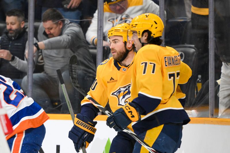 Apr 8, 2025; Nashville, Tennessee, USA;  Nashville Predators center Ryan O'Reilly (90) celebrates his goal with right wing Luke Evangelista (77) against the New York Islanders during the first period at Bridgestone Arena. Mandatory Credit: Steve Roberts-Imagn Images