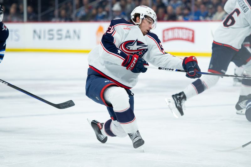 Jan 9, 2024; Winnipeg, Manitoba, CAN; Columbus Blue Jackets forward Yegor Chinakhov (59) takes a shot on the net against the Winnipeg Jets during the first period at Canada Life Centre. Mandatory Credit: Terrence Lee-USA TODAY Sports