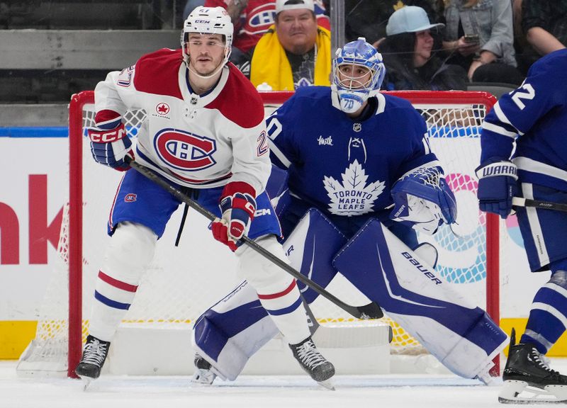 Sep 27, 2025; Toronto, Ontario, CAN; Toronto Maple Leafs goaltender Artur Akhtyamov (70) and Montreal Canadiens forward Samuel Blais (27) look for the puck during the third period at Scotiabank Arena. Mandatory Credit: John E. Sokolowski-Imagn Images