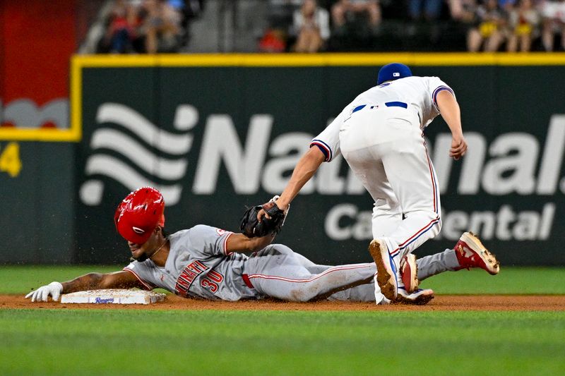 Apr 27, 2024; Arlington, Texas, USA; Texas Rangers shortstop Corey Seager (5) tags out Cincinnati Reds center fielder Will Benson (30) as he is caught attempting to steal second base during the fifth inning at Globe Life Field. Mandatory Credit: Jerome Miron-USA TODAY Sports