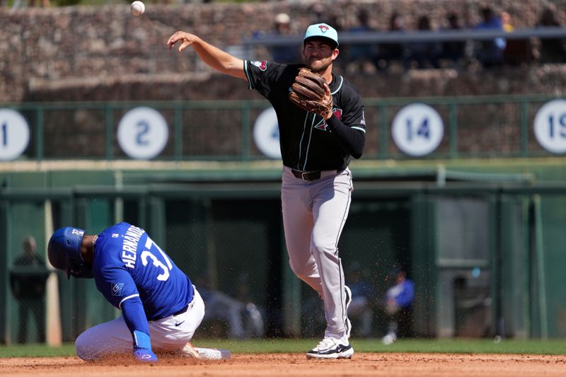 Mar 10, 2025; Phoenix, Arizona, USA; Arizona Diamondbacks infielder Connor Kaiser (65) throws to first base after forcing out Los Angeles Dodgers outfielder Teoscar Hernández (37) at second during the first inning at Camelback Ranch-Glendale. Mandatory Credit: Joe Camporeale-Imagn Images