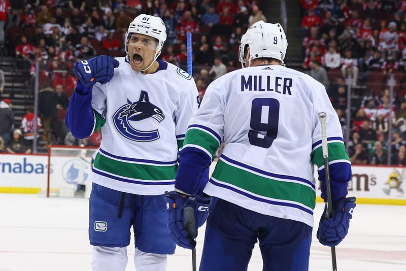 Jan 6, 2024; Newark, New Jersey, USA; Vancouver Canucks center Dakota Joshua (81) celebrates his goal against the New Jersey Devils during the third period at Prudential Center. Mandatory Credit: Ed Mulholland-USA TODAY Sports