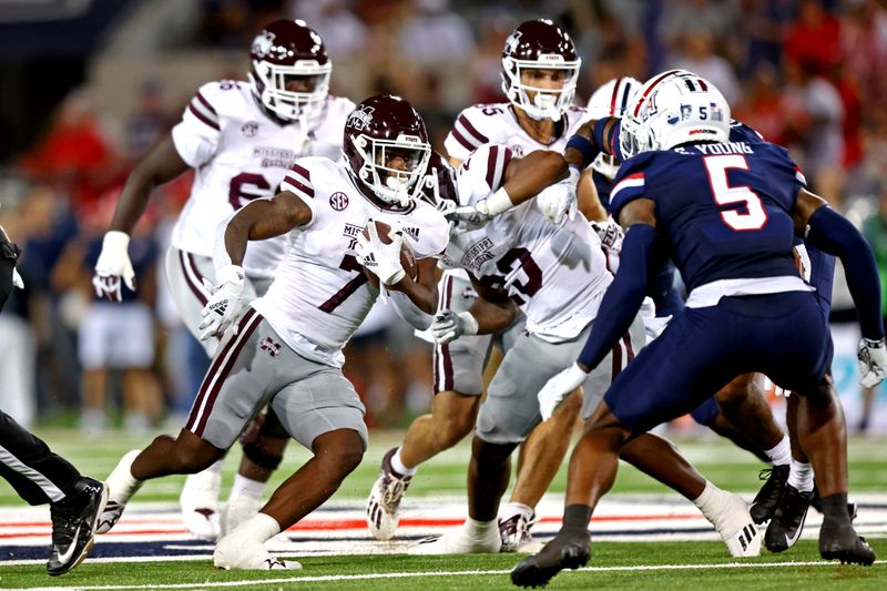 Sep 10, 2022; Tucson, Arizona, USA; Mississippi State Bulldogs running back Jo'quavious Marks (7) runs the ball against Arizona Wildcats safety Christian Young (5) at Arizona Stadium. Mandatory Credit: Mark J. Rebilas-USA TODAY Sports