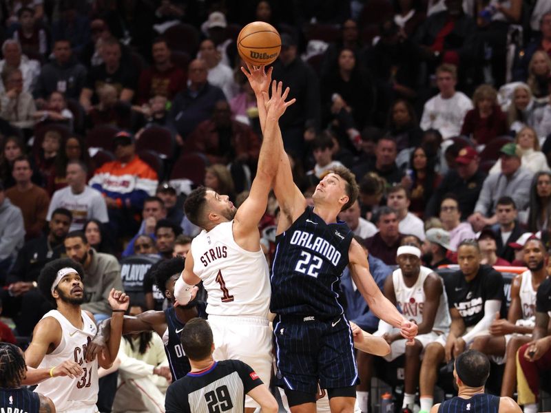 CLEVELAND, OH - APRIL 20: Max Strus #1 of the Cleveland Cavaliers and Franz Wagner #22 of the Orlando Magic go up for the jump ball during Round One Game One of the 2024 NBA Playoffs on April 20, 2024 at Rocket Mortgage FieldHouse in Cleveland, Ohio. NOTE TO USER: User expressly acknowledges and agrees that, by downloading and/or using this Photograph, user is consenting to the terms and conditions of the Getty Images License Agreement. Mandatory Copyright Notice: Copyright 2024 NBAE (Photo by  Lauren Leigh Bacho/NBAE via Getty Images)