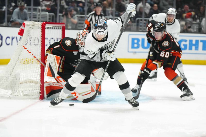 Apr 13, 2024; Los Angeles, California, USA; LA Kings right wing Viktor Arvidsson (33) battles for the puck against Anaheim Ducks goaltender Lukas Dostal (1) and defenseman Jackson LaCombe (60) in the second period at Crypto.com Arena. Mandatory Credit: Kirby Lee-USA TODAY Sports