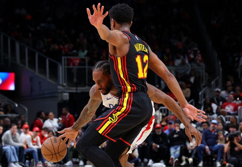 ATLANTA, GEORGIA - FEBRUARY 05:  Kawhi Leonard #2 of the LA Clippers drives against De'Andre Hunter #12 of the Atlanta Hawks during the fourth quarter at State Farm Arena on February 05, 2024 in Atlanta, Georgia.  NOTE TO USER: User expressly acknowledges and agrees that, by downloading and/or using this photograph, user is consenting to the terms and conditions of the Getty Images License Agreement.  (Photo by Kevin C. Cox/Getty Images)