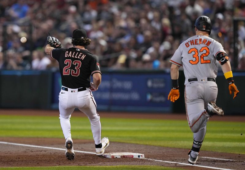 Sep 3, 2023; Phoenix, Arizona, USA; Arizona Diamondbacks starting pitcher Zac Gallen (23) fields a throw to force out Baltimore Orioles first baseman Ryan O'Hearn (32) at first base during the third inning at Chase Field. Mandatory Credit: Joe Camporeale-USA TODAY Sports