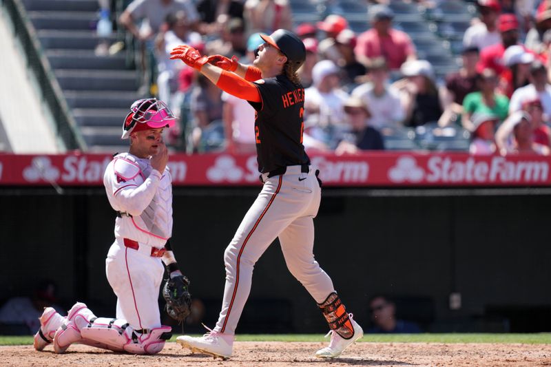 May 11, 2025; Anaheim, California, USA; Baltimore Orioles shortstop Gunnar Henderson (2) celebrates after hitting a two-run home run in the sixth inning as Los Angeles Angels catcher Logan O'Hoppe (14) watches at Angel Stadium. Mandatory Credit: Kirby Lee-Imagn Images