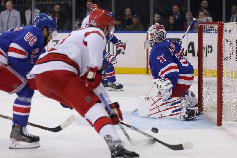 May 13, 2024; New York, New York, USA; New York Rangers goaltender Igor Shesterkin (31) watches as Carolina Hurricanes center Jesperi Kotkaniemi (82) skates with the puck against Rangers defenseman Erik Gustafsson (56) during the first period of game five of the second round of the 2024 Stanley Cup Playoffs at Madison Square Garden. Mandatory Credit: Brad Penner-USA TODAY Sports