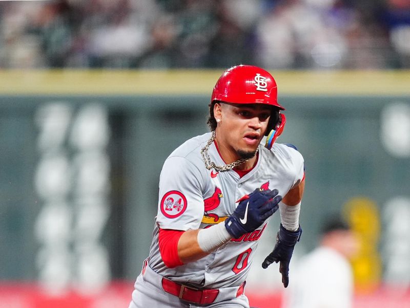 Sep 25, 2024; Denver, Colorado, USA; St. Louis Cardinals shortstop Masyn Winn (0) triples in the third inning against the Colorado Rockies at Coors Field. Mandatory Credit: Ron Chenoy-Imagn Images