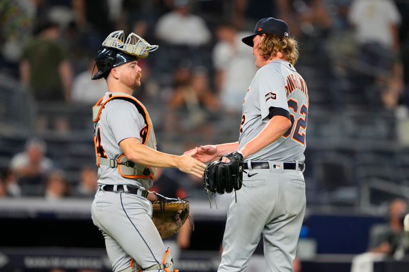 Sep 7, 2023; Bronx, New York, USA; Detroit Tigers catcher Jake Rogers (34) and pitcher Trey Wingenter (62) shake hands to celebrate the victory against the New York Yankees after the ninth inning at Yankee Stadium. Mandatory Credit: Gregory Fisher-USA TODAY Sports