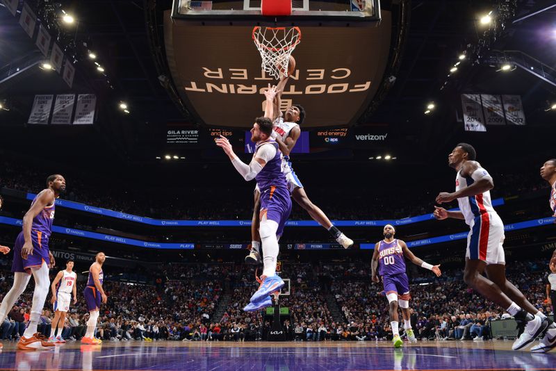 PHOENIX, AZ - FEBRUARY 14:  Ausar Thompson #9 of the Detroit Pistons drives to the basket during the game against Jusuf Nurkic #20 of the Phoenix Suns on February 14, 2024 at Footprint Center in Phoenix, Arizona. NOTE TO USER: User expressly acknowledges and agrees that, by downloading and or using this photograph, user is consenting to the terms and conditions of the Getty Images License Agreement. Mandatory Copyright Notice: Copyright 2024 NBAE (Photo by Barry Gossage/NBAE via Getty Images)