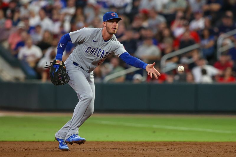 Sep 28, 2023; Atlanta, Georgia, USA; Chicago Cubs first baseman Cody Bellinger (24) throws a runner out at first against the Atlanta Braves in the first inning at Truist Park. Mandatory Credit: Brett Davis-USA TODAY Sports